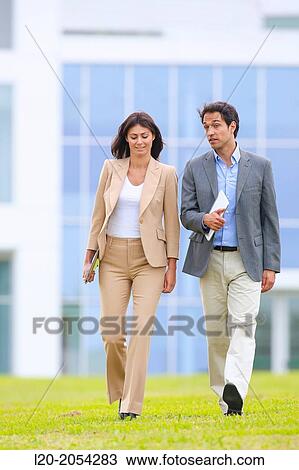 Businessman and businesswoman walking in business center. San Sebastian Technology Park. Donostia. Gipuzkoa. Basque Country. Spain. View Large Photo Image Stock Image - Businessman and businesswoman walking in business center. San Sebastian Technology Park. Donostia. Gipuzkoa. Basque Country. Spain.. Fotosearch