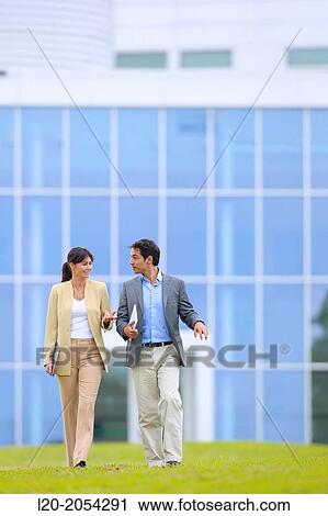 Businessman and businesswoman walking in business center. San Sebastian Technology Park. Donostia. Gipuzkoa. Basque Country. Spain. View Large Photo Image Stock Image - Businessman and businesswoman walking in business center. San Sebastian Technology Park. Donostia. Gipuzkoa. Basque Country. Spain.. Fotosearch