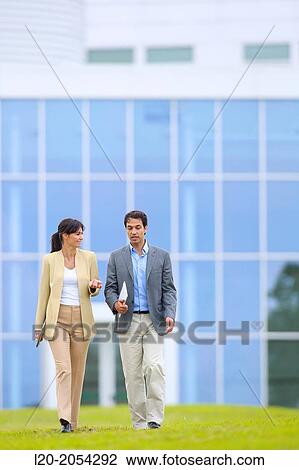 Businessman and businesswoman walking in business center. San Sebastian Technology Park. Donostia. Gipuzkoa. Basque Country. Spain. View Large Photo Image Stock Image - Businessman and businesswoman walking in business center. San Sebastian Technology Park. Donostia. Gipuzkoa. Basque Country. Spain.. Fotosearch