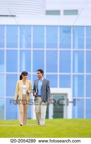 Businessman and businesswoman walking in business center. San Sebastian Technology Park. Donostia. Gipuzkoa. Basque Country. Spain. View Large Photo Image Stock Photo - Businessman and businesswoman walking in business center. San Sebastian Technology Park. Donostia. Gipuzkoa. Basque Country. Spain.. Fotosearch