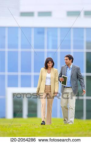 Businessman and businesswoman walking in business center. San Sebastian Technology Park. Donostia. Gipuzkoa. Basque Country. Spain. View Large Photo Image Stock Photograph - Businessman and businesswoman walking in business center. San Sebastian Technology Park. Donostia. Gipuzkoa. Basque Country. Spain.. Fotosearch