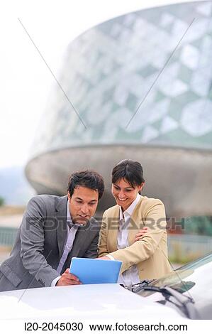 Businessman and businesswoman with tablet in parking business center. San Sebastian Technology Park. Donostia. Gipuzkoa. Basque Country. Spain. View Large Photo Image Stock Image - Businessman and businesswoman with tablet in parking business center. San Sebastian Technology Park. Donostia. Gipuzkoa. Basque Country. Spain.. Fotosearch