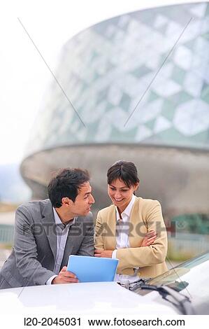 Businessman and businesswoman with tablet in parking business center. San Sebastian Technology Park. Donostia. Gipuzkoa. Basque Country. Spain. View Large Photo Image Stock Image - Businessman and businesswoman with tablet in parking business center. San Sebastian Technology Park. Donostia. Gipuzkoa. Basque Country. Spain.. Fotosearch