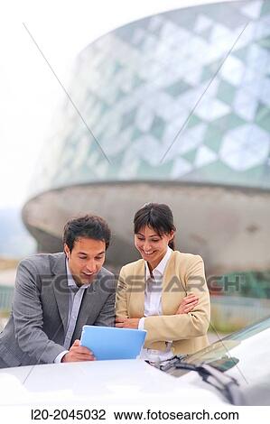Businessman and businesswoman with tablet in parking business center. San Sebastian Technology Park. Donostia. Gipuzkoa. Basque Country. Spain. View Large Photo Image Stock Image - Businessman and businesswoman with tablet in parking business center. San Sebastian Technology Park. Donostia. Gipuzkoa. Basque Country. Spain.. Fotosearch