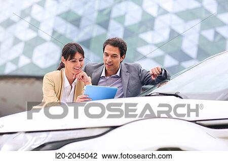 Businessman and businesswoman with tablet in parking business center. San Sebastian Technology Park. Donostia. Gipuzkoa. Basque Country. Spain. View Large Photo Image Stock Image - Businessman and businesswoman with tablet in parking business center. San Sebastian Technology Park. Donostia. Gipuzkoa. Basque Country. Spain.. Fotosearch