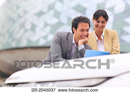 Businessman and businesswoman with tablet in parking business center. San Sebastian Technology Park. Donostia. Gipuzkoa. Basque Country. Spain. View Large Photo Image Stock Photo - Businessman and businesswoman with tablet in parking business center. San Sebastian Technology Park. Donostia. Gipuzkoa. Basque Country. Spain.. Fotosearch