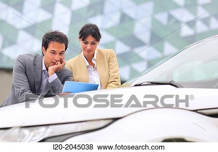 Businessman and businesswoman with tablet in parking business center. San Sebastian Technology Park. Donostia. Gipuzkoa. Basque Country. Spain. View Large Photo Image Stock Photo - Businessman and businesswoman with tablet in parking business center. San Sebastian Technology Park. Donostia. Gipuzkoa. Basque Country. Spain.. Fotosearch