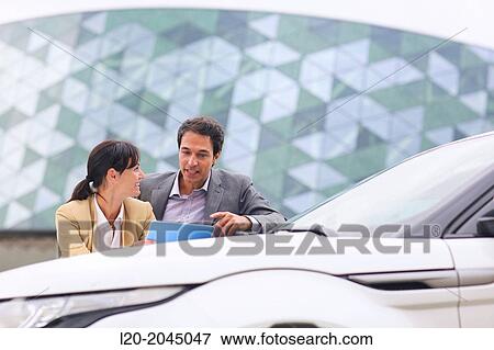 Businessman and businesswoman with tablet in parking business center. San Sebastian Technology Park. Donostia. Gipuzkoa. Basque Country. Spain. View Large Photo Image Stock Photo - Businessman and businesswoman with tablet in parking business center. San Sebastian Technology Park. Donostia. Gipuzkoa. Basque Country. Spain.. Fotosearch