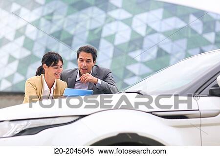 Businessman and businesswoman with tablet in parking business center. San Sebastian Technology Park. Donostia. Gipuzkoa. Basque Country. Spain. View Large Photo Image Stock Photography - Businessman and businesswoman with tablet in parking business center. San Sebastian Technology Park. Donostia. Gipuzkoa. Basque Country. Spain.. Fotosearch