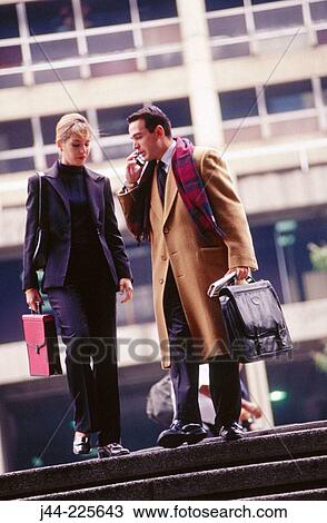 Stock Image - Businessman and woman in the street. Fotosearch