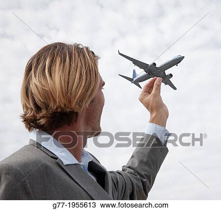 Businessman catching a plane with his hand, Miami, USA View Large Photo Image Stock Image - Businessman catching a plane with his hand, Miami, USA. Fotosearch