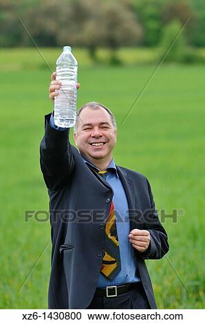 businessman drink water at green field View Large Photo Image Stock Image - businessman drink water at green field. Fotosearch