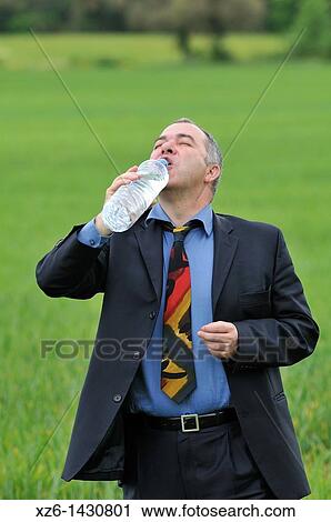 businessman drink water at green field View Large Photo Image Stock Image - businessman drink water at green field. Fotosearch
