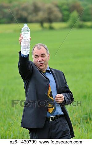 businessman drink water at green field View Large Photo Image Stock Photo - businessman drink water at green field. Fotosearch