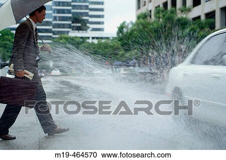 businessman gets splashed by a passing car View Large Photo Image Stock Image - businessman gets splashed by a passing car. Fotosearch