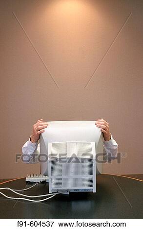 Businessman grabbing monitor View Large Photo Image Stock Photo - Businessman grabbing monitor. Fotosearch