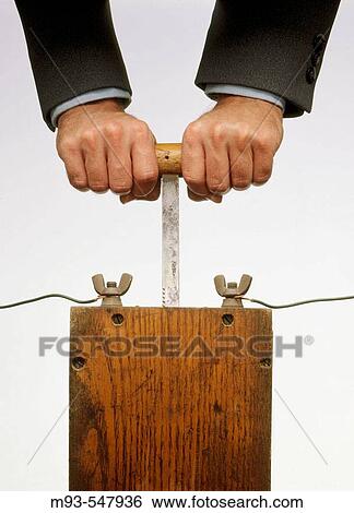Stock Photograph - Businessman hands pushing down on detonator. Fotosearch
