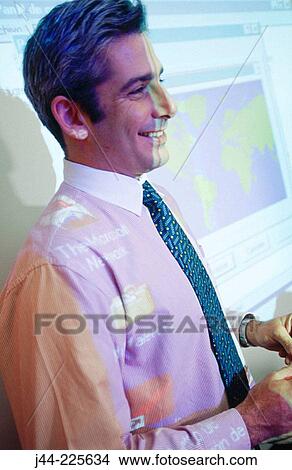 Businessman in conference room during presentation View Large Photo Image Picture - Businessman in conference room during presentation. Fotosearch