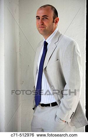 Businessman in corner looking into camera View Large Photo Image Stock Photograph - Businessman in corner looking into camera. Fotosearch