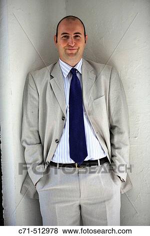 Businessman in corner smiling into camera View Large Photo Image Stock Photo - Businessman in corner smiling into camera. Fotosearch