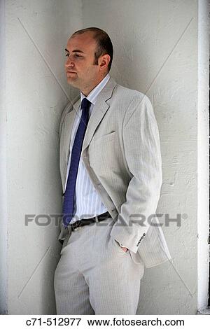 Stock Photo - Businessman in corner thinking. Fotosearch