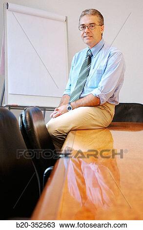 Stock Image - Businessman in meeting room. Fotosearch