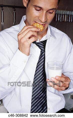 Stock Image - Businessman in the kitchen. Fotosearch