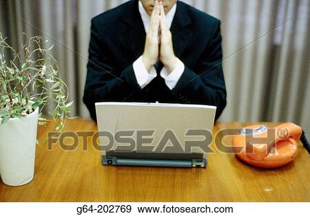 Stock Photo - Businessman, laptop and phone. Fotosearch