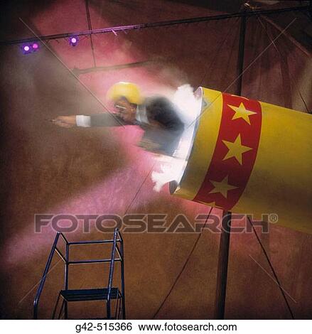 Stock Photograph - Businessman launching from circus cannon.. Fotosearch