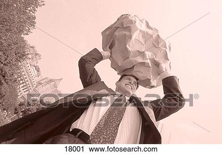 Stock Image - Businessman lifting rock. Fotosearch