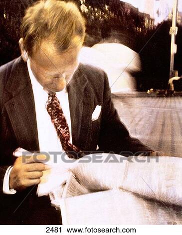 Businessman looking at newspaper View Large Photo Image Stock Image - Businessman looking at newspaper. Fotosearch