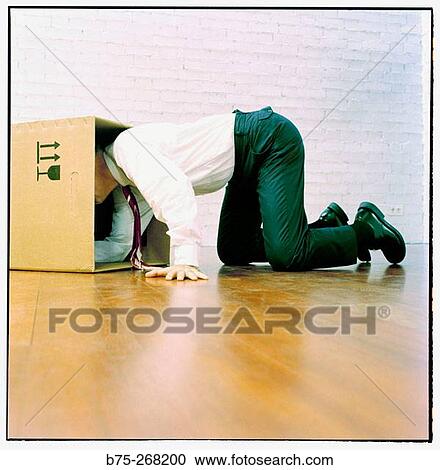 Businessman looking for something in a cardboard box View Large Photo Image Stock Image - Businessman looking for something in a cardboard box. Fotosearch