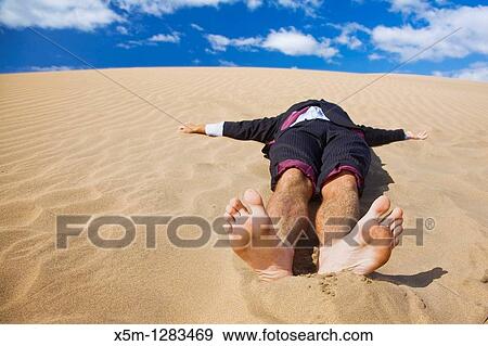 Businessman lost in the desert View Large Photo Image Stock Photo - Businessman lost in the desert. Fotosearch