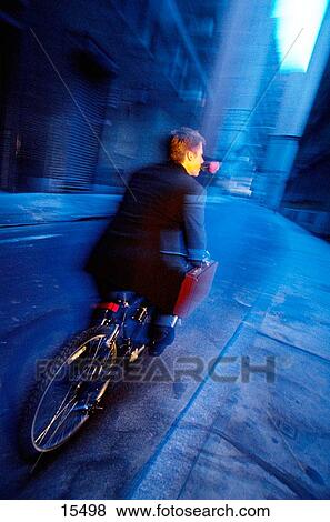 Businessman on bicycle with rose View Large Photo Image Stock Photo - Businessman on bicycle with rose. Fotosearch