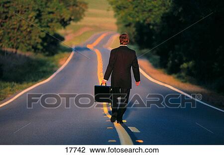 Businessman on lonely road View Large Photo Image Stock Image - Businessman on lonely road. Fotosearch