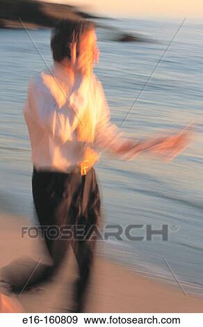 Businessman on phone at the beach View Large Photo Image Stock Photo - Businessman on phone at the beach. Fotosearch