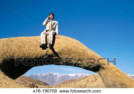 Businessman on phone on arch View Large Photo Image Stock Photo - Businessman on phone on arch. Fotosearch
