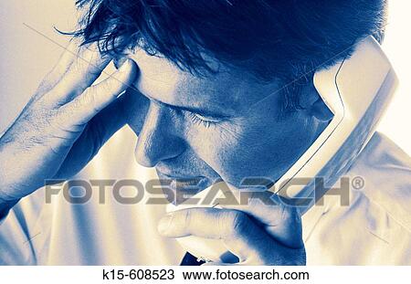 Businessman on telephone, holding head & looking worried View Large Photo Image Stock Image - Businessman on telephone, holding head & looking worried. Fotosearch