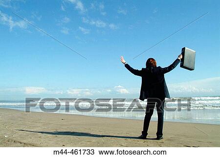 Stock Image - Businessman on the beach. Fotosearch