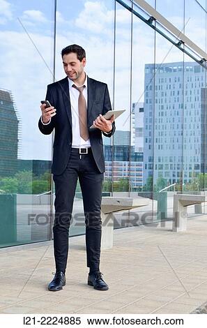 Stock Photography - Businessman on the phone with digital tablet.. Fotosearch