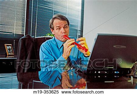 Businessman playing flute to his laptop View Large Photo Image Stock Photography - Businessman playing flute to his laptop. Fotosearch