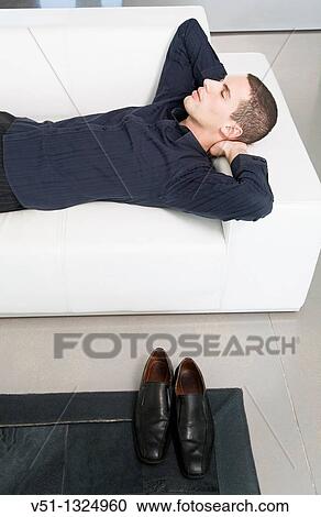 Businessman relaxing in sofa View Large Photo Image Stock Image - Businessman relaxing in sofa. Fotosearch