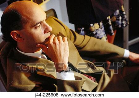Businessman sitting in deep thought View Large Photo Image Stock Photograph - Businessman sitting in deep thought. Fotosearch