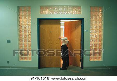 Businessman sticking his head into the company boardroom View Large Photo Image Stock Photograph - Businessman sticking his head into the company boardroom. Fotosearch