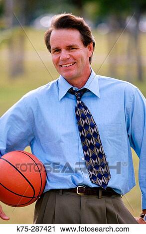 businessman taking a break with his basketball View Large Photo Image Stock Image - businessman taking a break with his basketball. Fotosearch