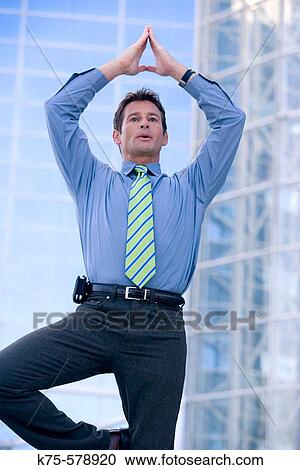 Businessman taking time to meditate View Large Photo Image Stock Image - Businessman taking time to meditate. Fotosearch