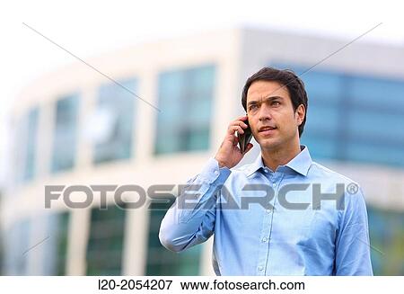 Stock Photo - Businessman talking on mobile phone in business center. San Sebastian Technology Park. Donostia. Gipuzkoa. Basque Country. Spain.. Fotosearch