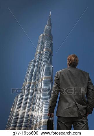 Businessman under high rise building, Dubai, UAE View Large Photo Image Stock Image - Businessman under high rise building, Dubai, UAE. Fotosearch