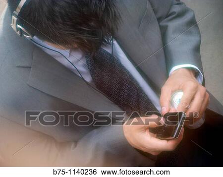 Stock Photograph - Businessman using cell phone. Fotosearch