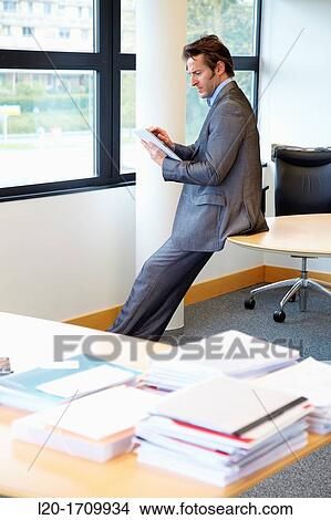 Businessman using tablet computer View Large Photo Image Picture - Businessman using tablet computer. Fotosearch
